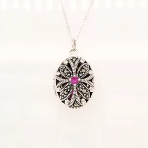 Flower locket in sterling silver with ruby and marcasite