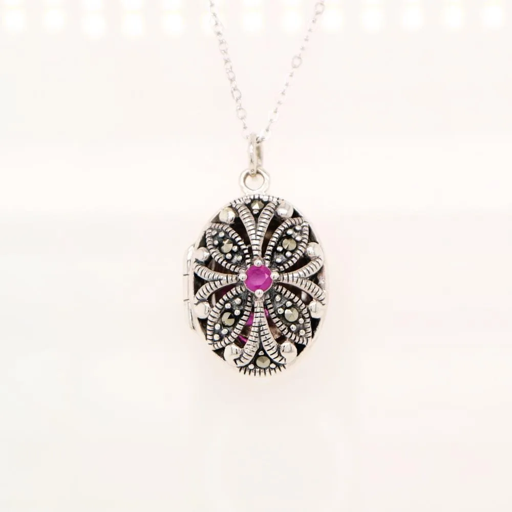 Flower locket in sterling silver with ruby and marcasite