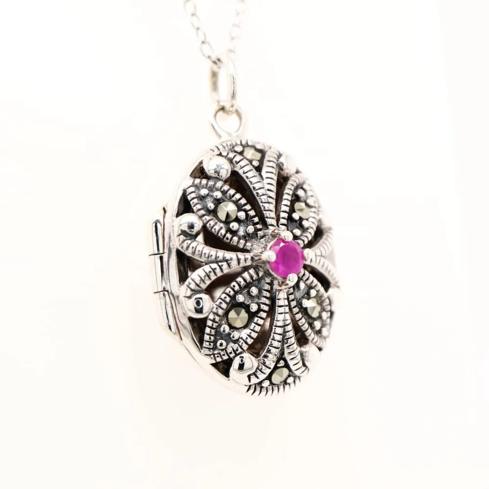 Flower locket in sterling silver with ruby and marcasite